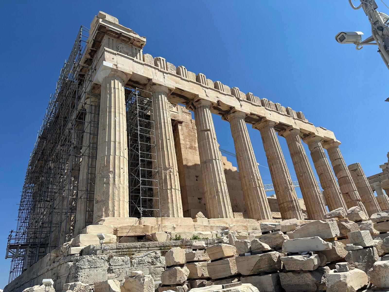 Side view of the Parthenon showing scaffolding during ongoing restoration work in Athens