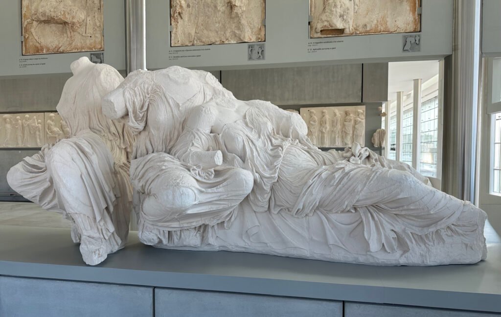 Sculpture of reclining goddesses from the Parthenon pediment on display at the Acropolis Museum in Athens