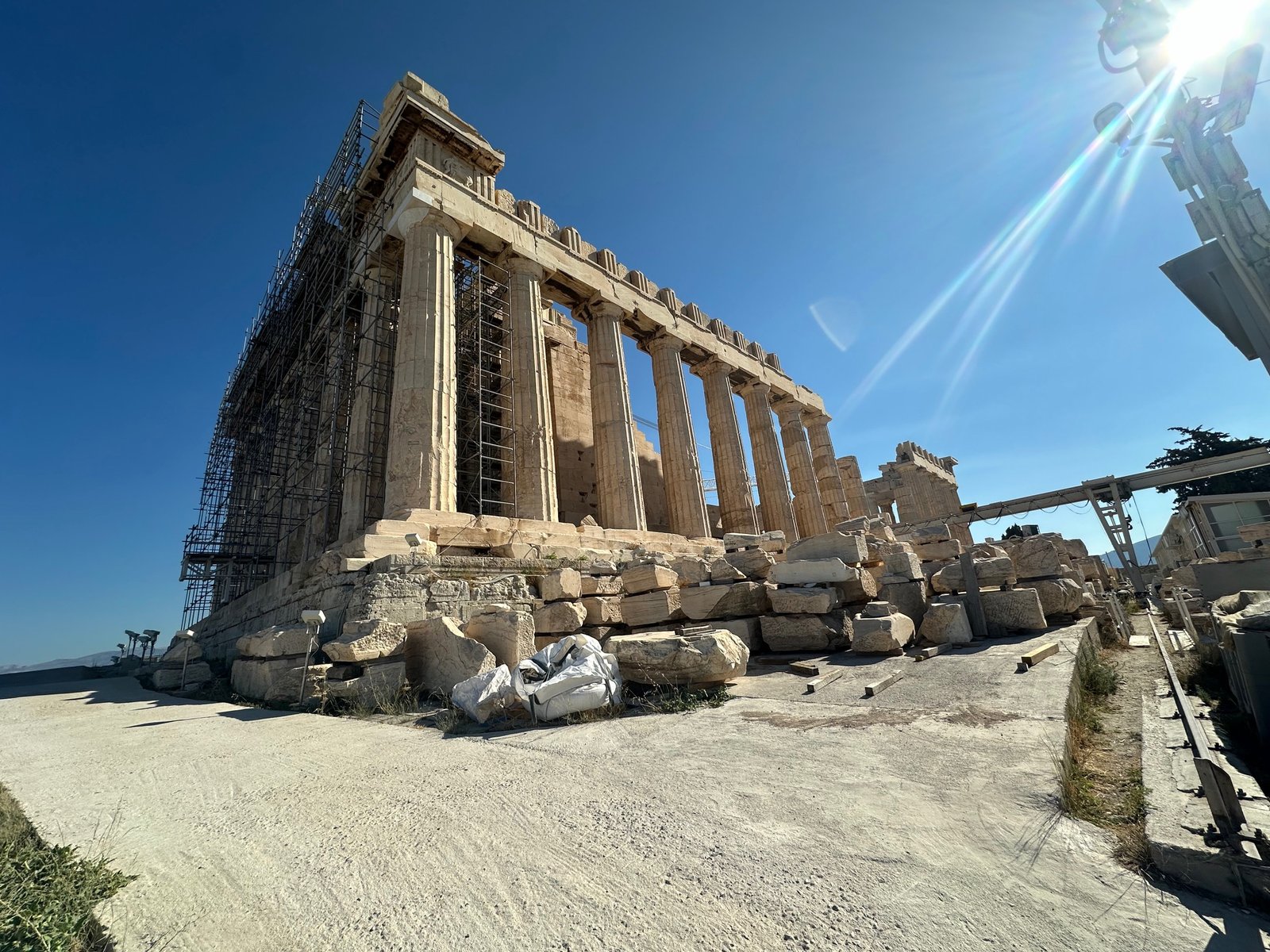 Front facade of the Parthenon under scaffolding during restoration, showcasing Athens' ancient architecture in a budget-friendly Greece travel itinerary