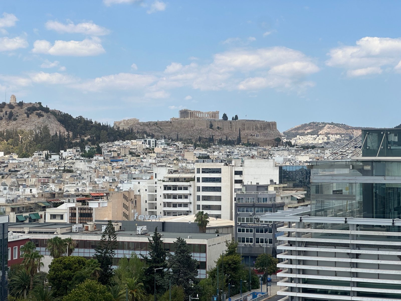 Panoramic view of the Acropolis from Grand Hyatt Athens rooftop, showcasing budget travel in Greece using rewards.